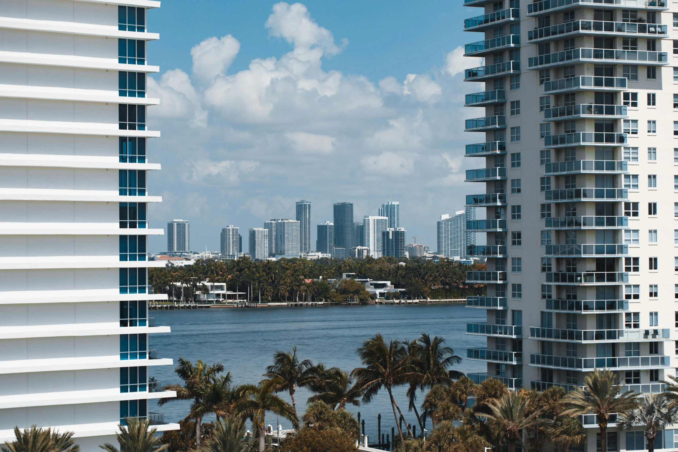 there are some tall buildings along the lake