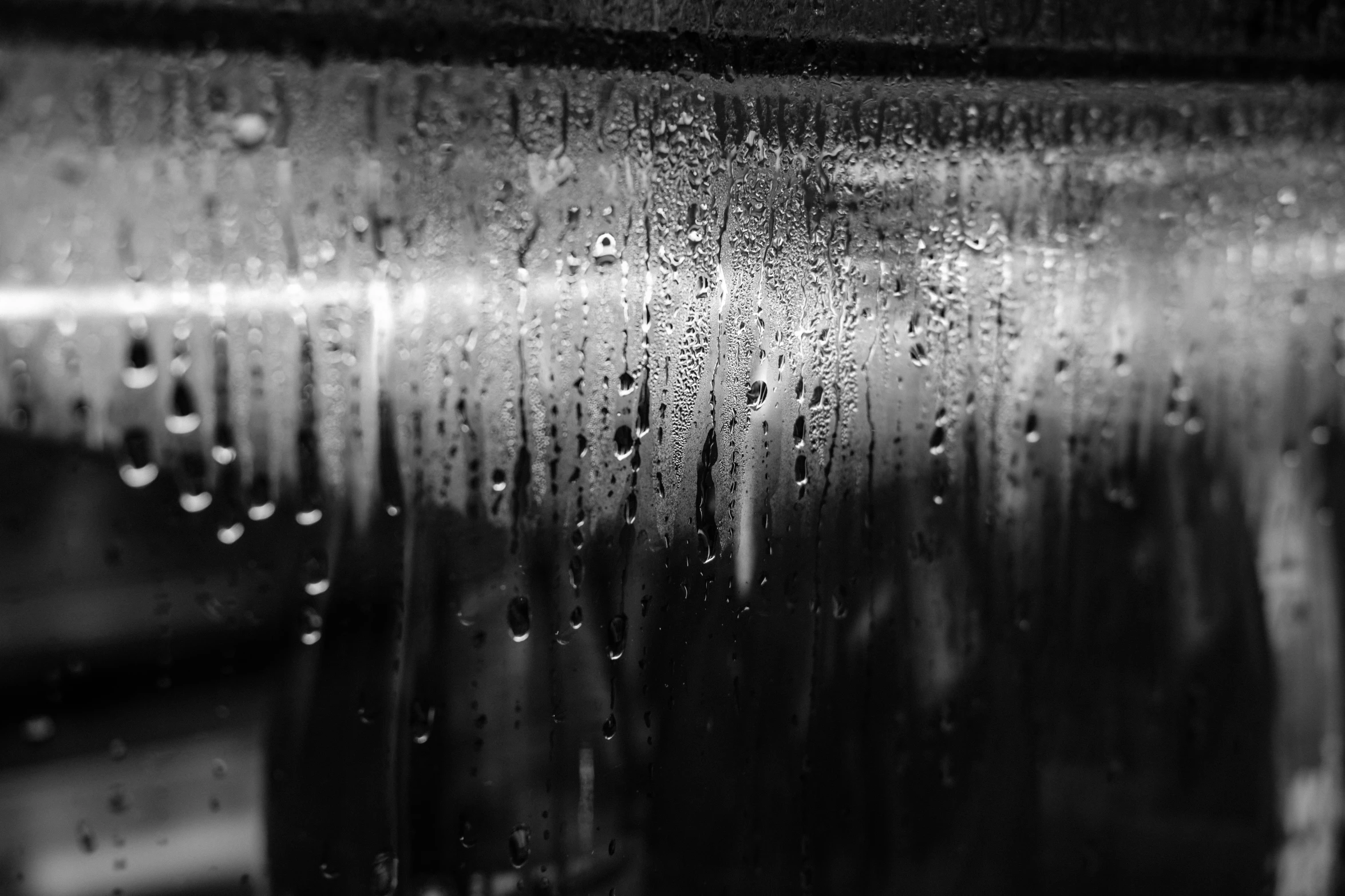 a rain covered wall in black and white