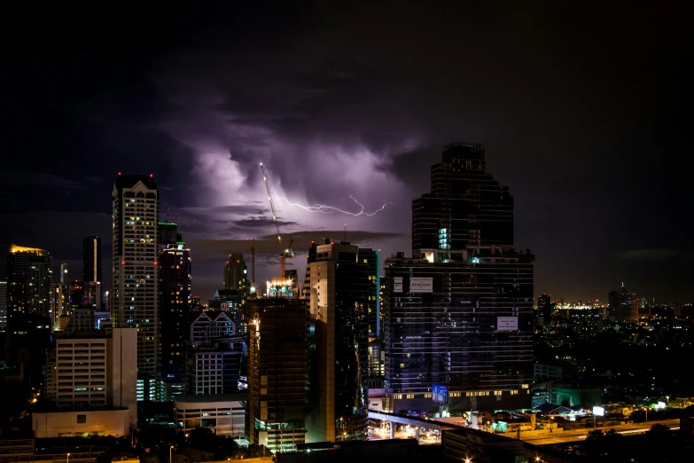 some buildings are lit up by a lightning storm