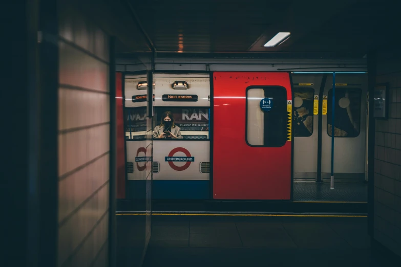 a subway train sitting next to a building