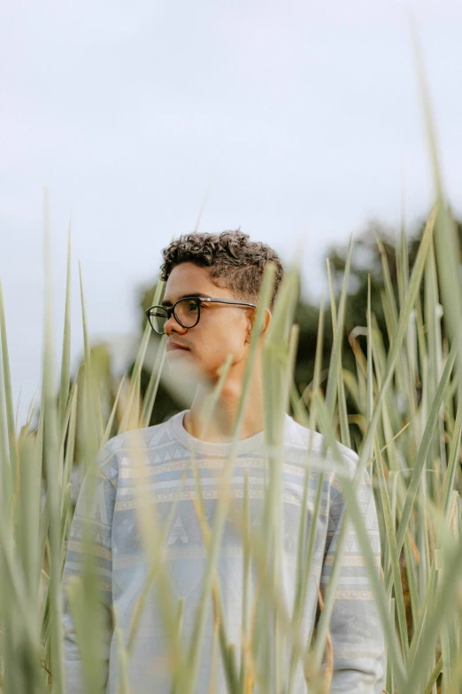 a man standing in the middle of tall grass