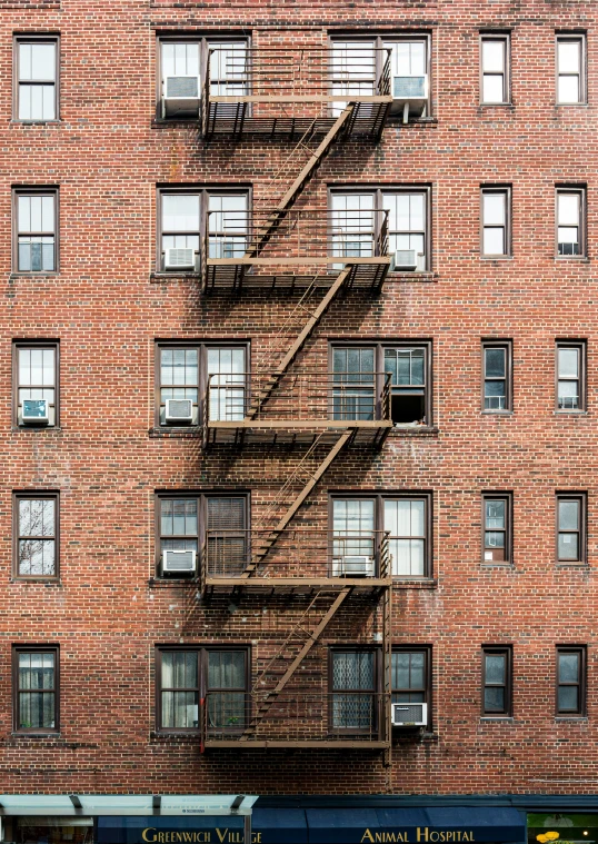 there is a very large fire escape against this brick building