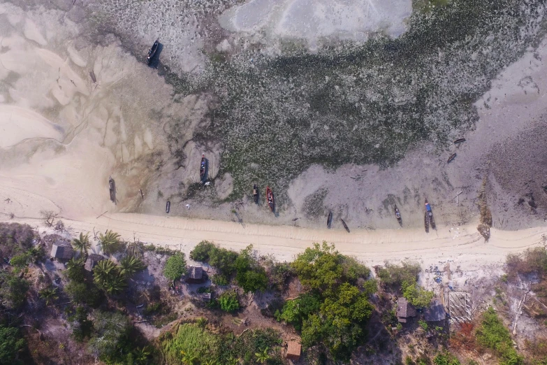 two hikers and people hiking up a beach