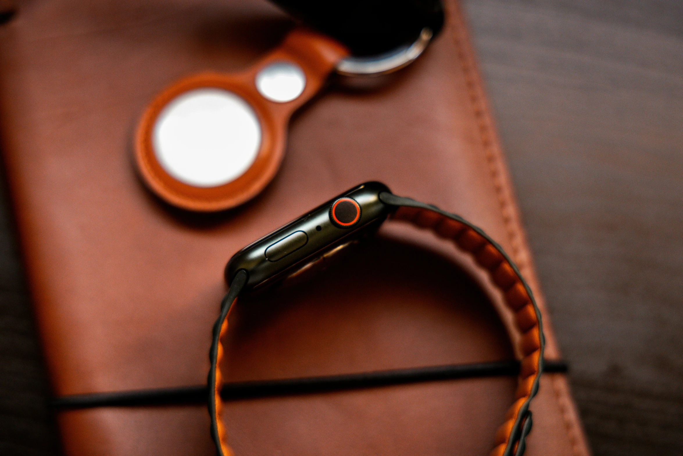 a cell phone is sitting on a leather pouch