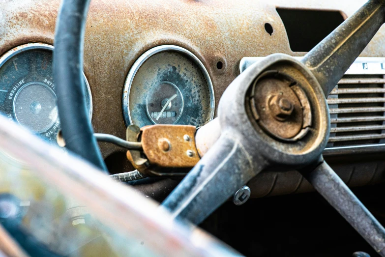 the dashboard of an old car that has been rusted