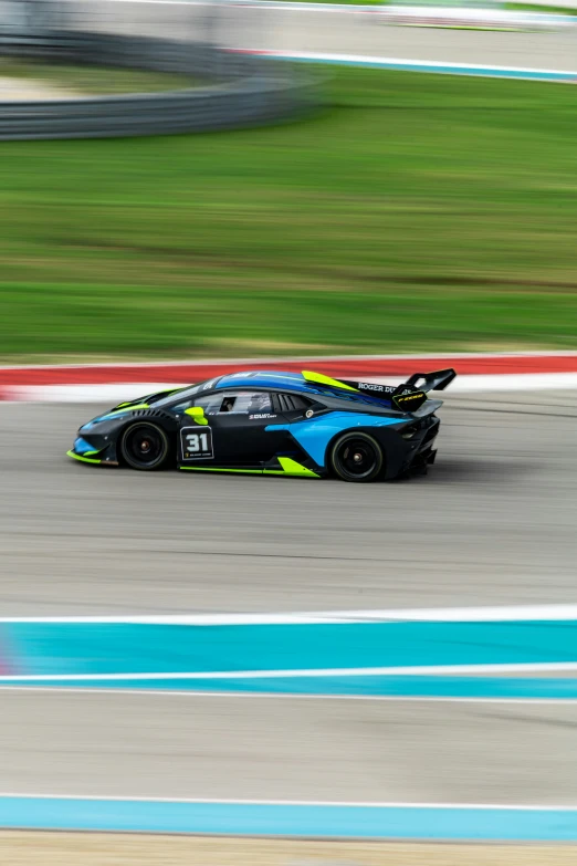 a car drives down the track with a blurry background