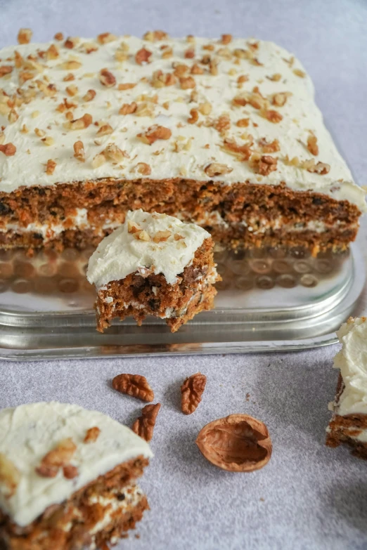 a square cake is cut in half on a table