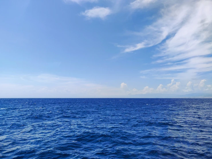 a lone boat is on the deep blue water