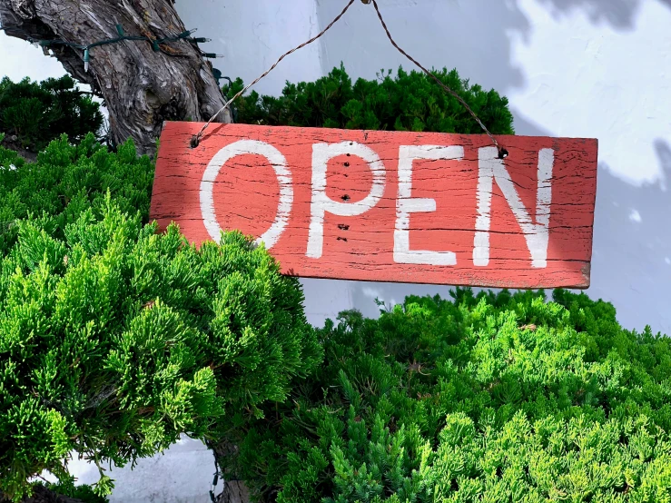 a sign on the side of a building that says open