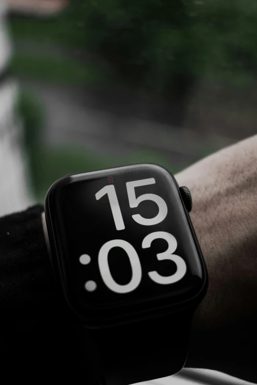 a person is holding on to an apple watch