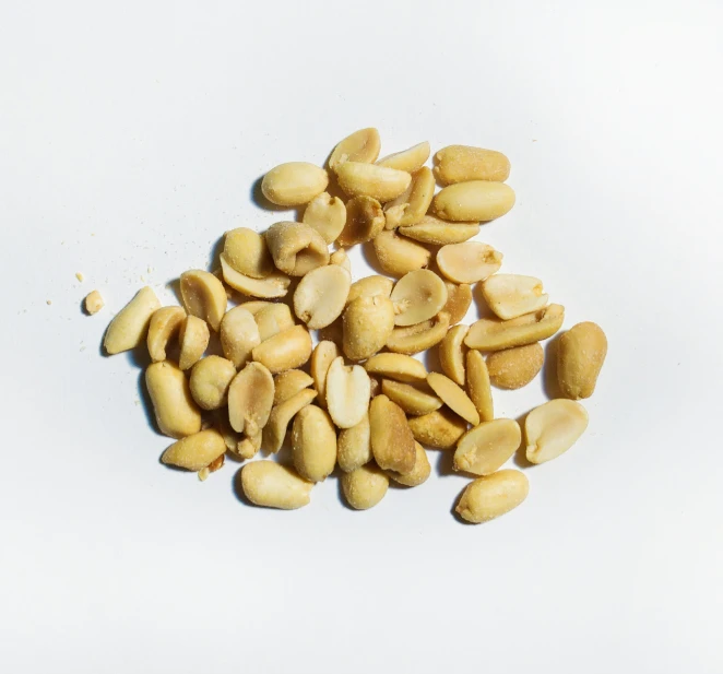 a pile of raw almonds is cut up