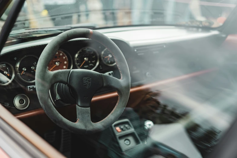 view of an interior from inside of a car with dashboard and controls