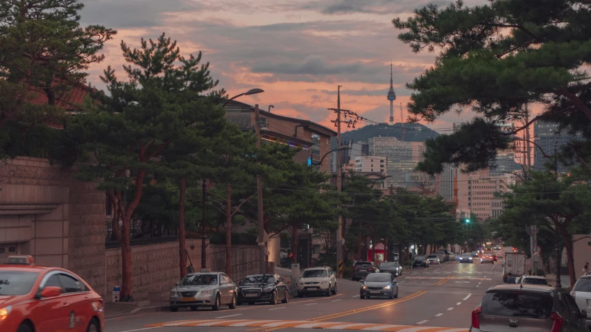 a street with cars stopped and buildings behind it