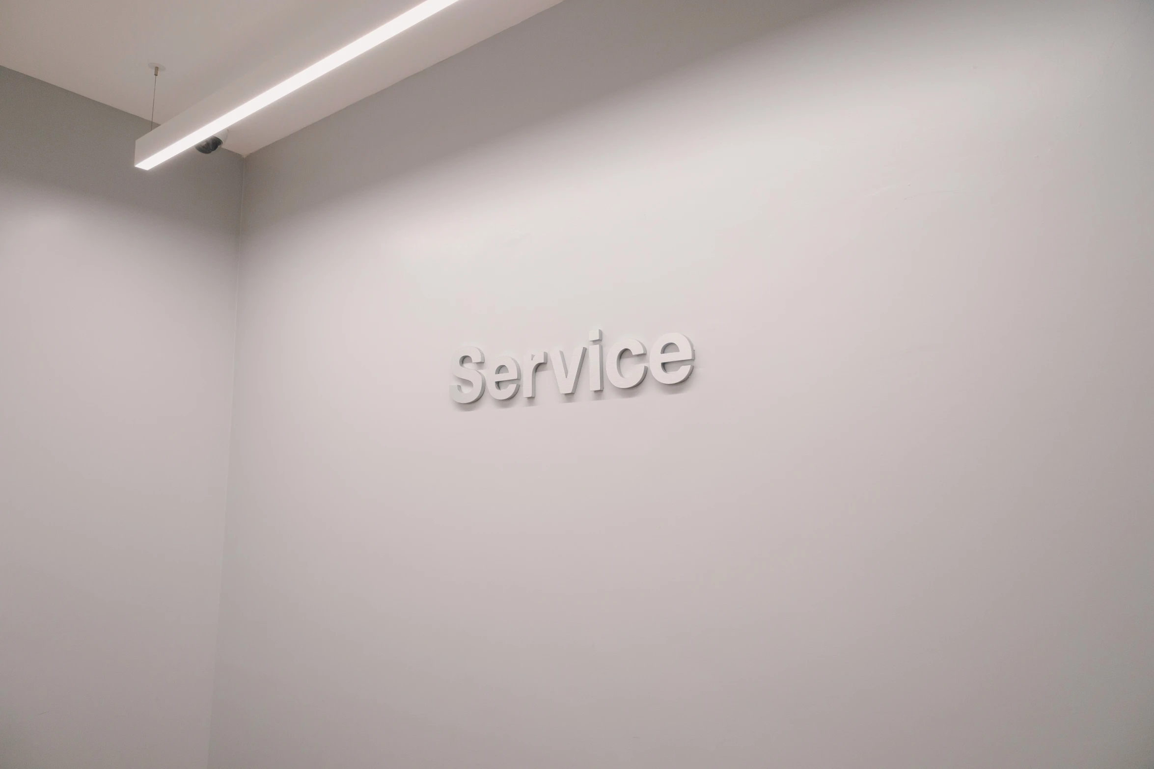 white room with light grey walls and the word service spelled on it