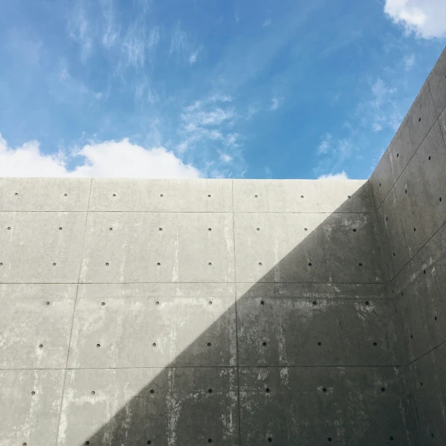 two concrete structures on the side of a wall
