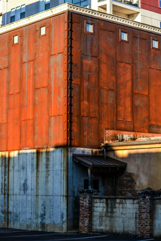 the corner of an urban area is covered in orange sheeting