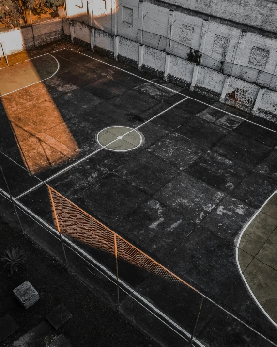 an empty tennis court with some old markings