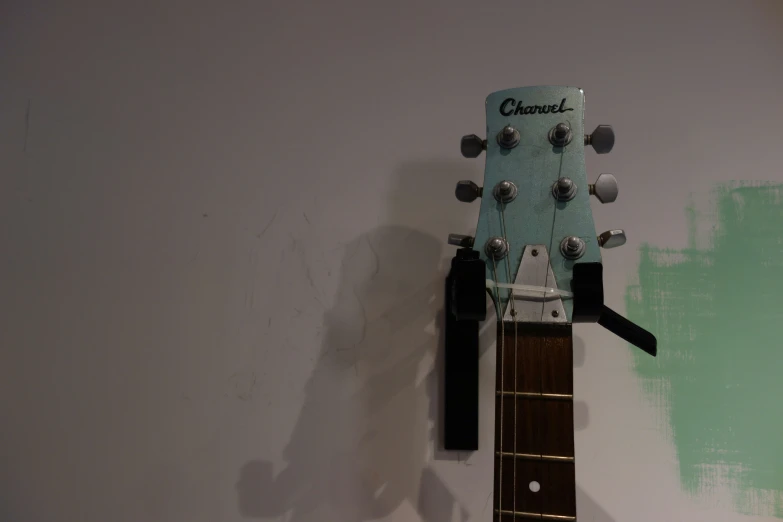 an acoustic guitar that is mounted on the wall