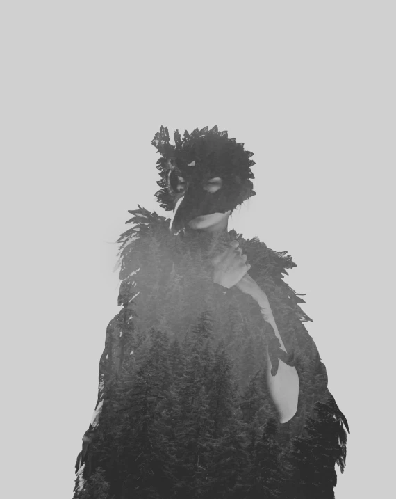 a silhouette is seen over a man covered in leaves