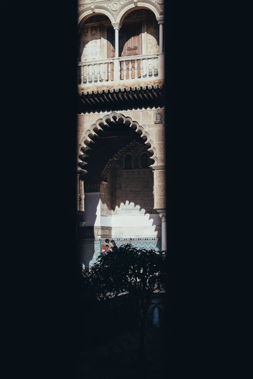 an arch and doorway leading to an ornate building