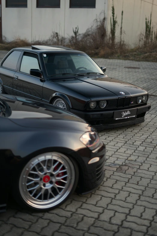 cars parked on a road with one black car