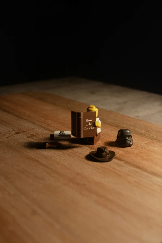 two cigarettes and one container sit on a table