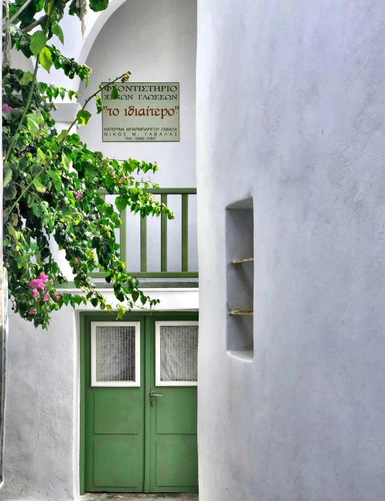 there is a green door in the doorway of the house