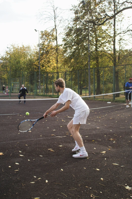 a man playing tennis and getting ready to hit the ball