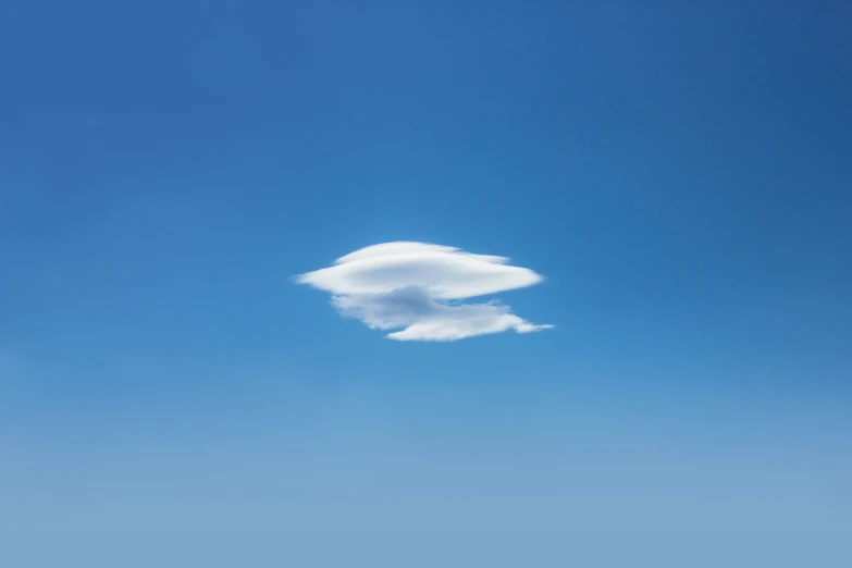 the view of a small white cloud against a blue sky