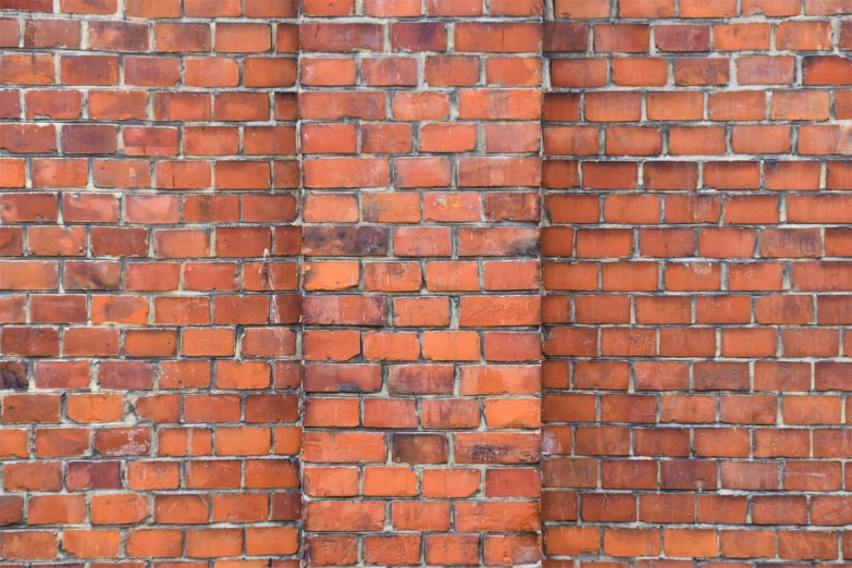 a brick wall with one corner painted red and the other has only two bricks