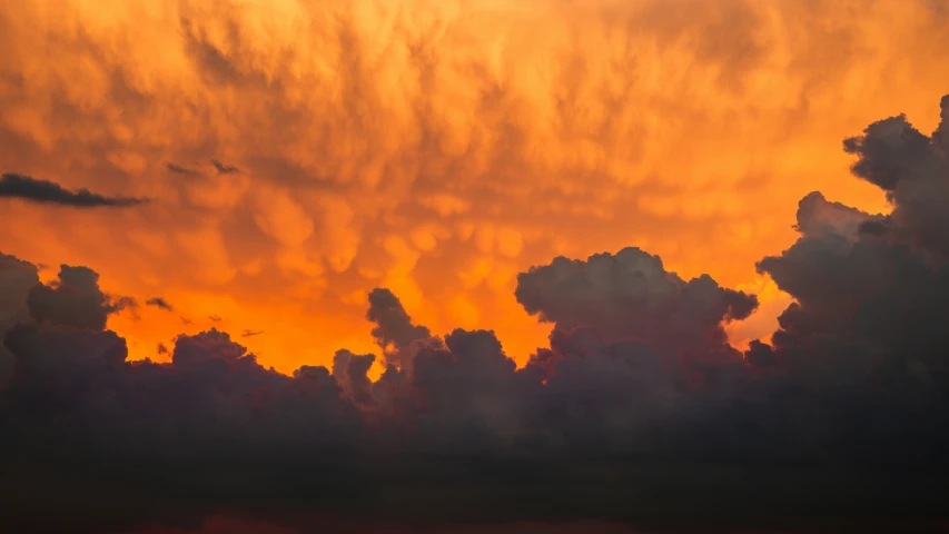 a plane is flying towards a yellow sunset