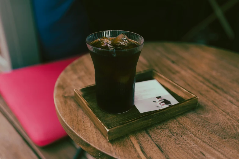 beverage with two cokes in it sitting on a table