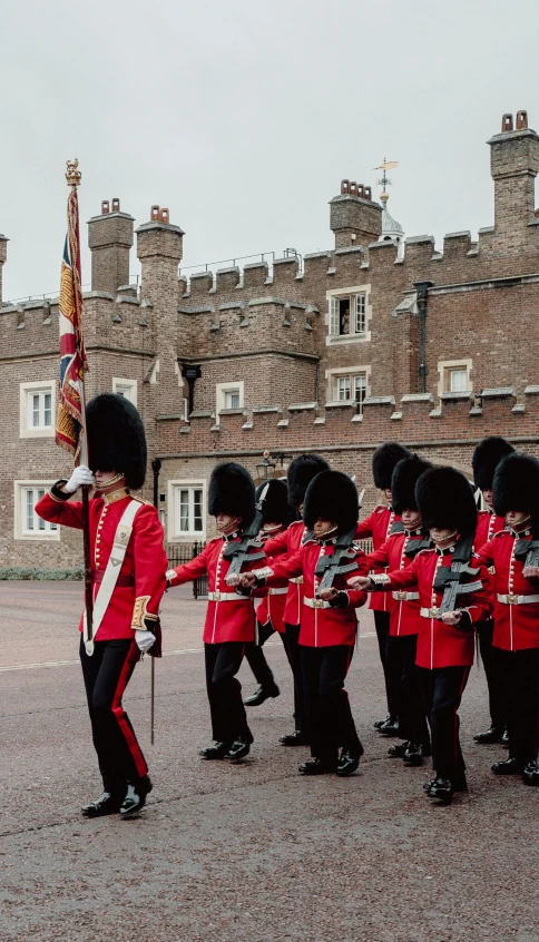 a group of men in red uniforms on a street