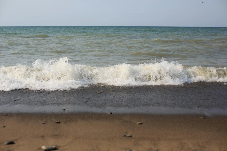 there is a wave coming in onto the beach