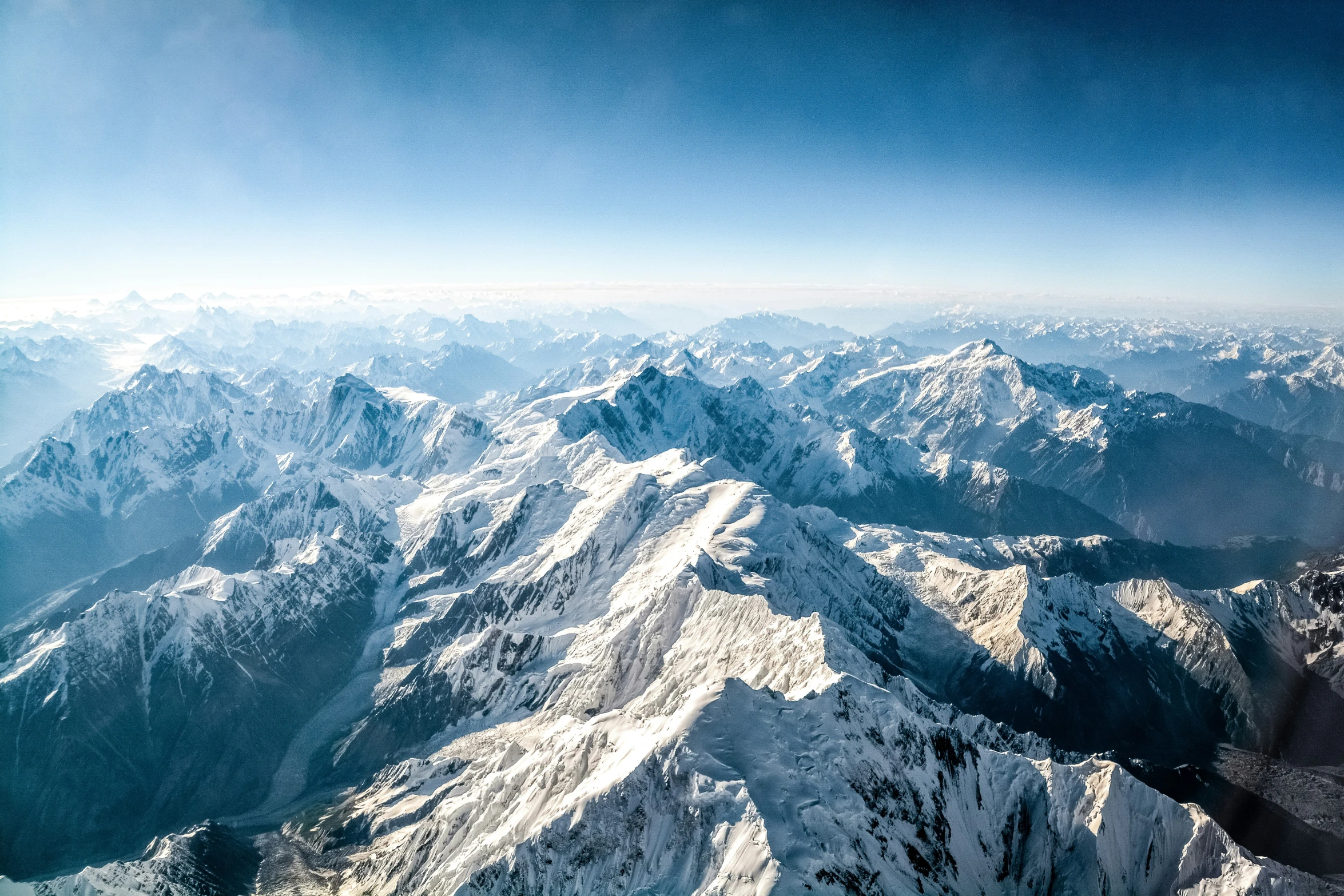 a view from an airplane looking at the mountains