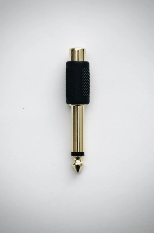 a gold - toned pen that has black ends with one end exposed