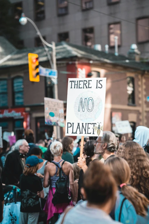 people are holding up signs that read there is no planet