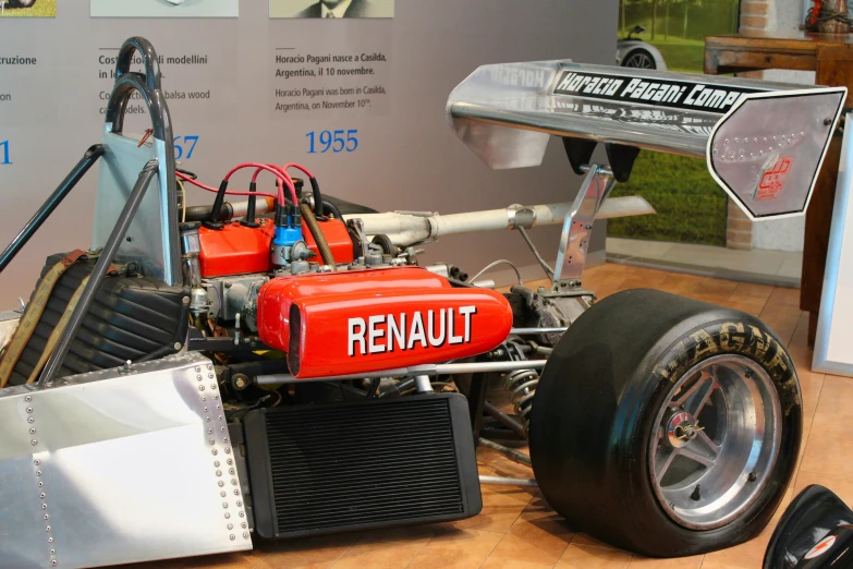 a red and black remote control racing car on display