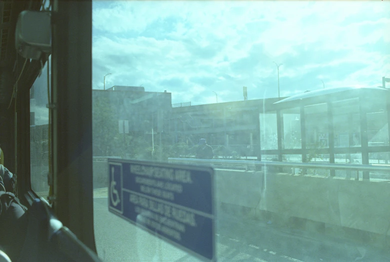 the view from inside the bus that you can see buildings and clouds