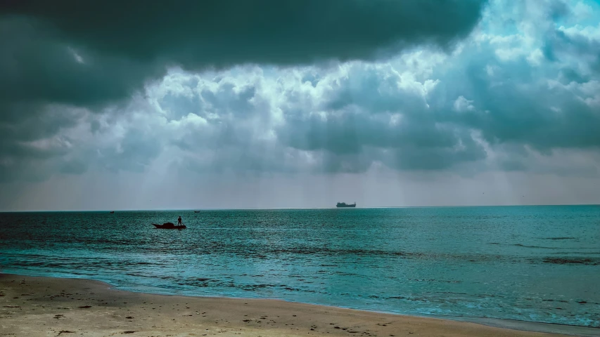 two people are on a small boat out in the ocean