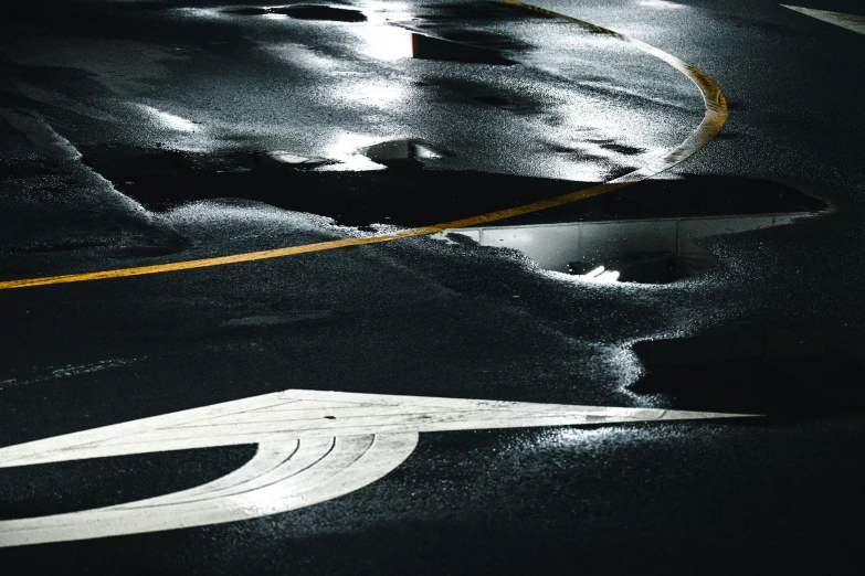 a parking lot that has some sort of water on it