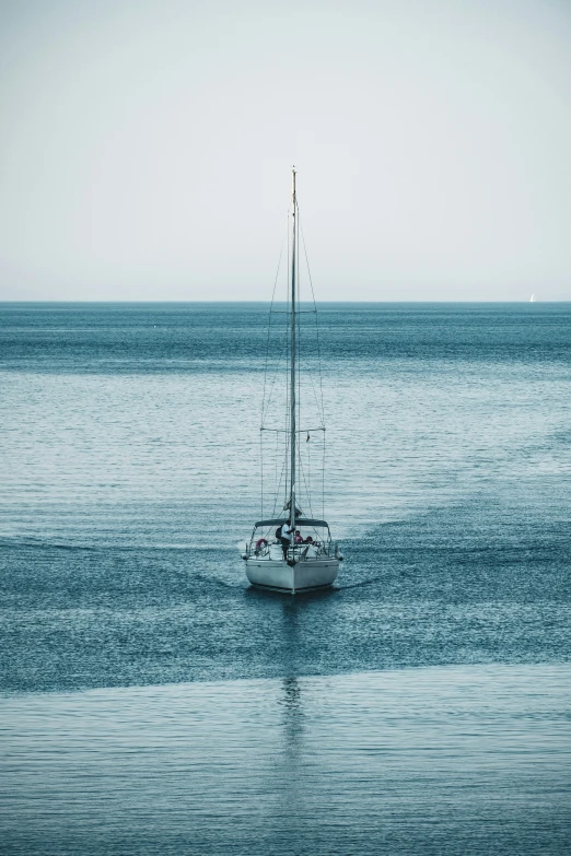 the sailboat is in the calm ocean water