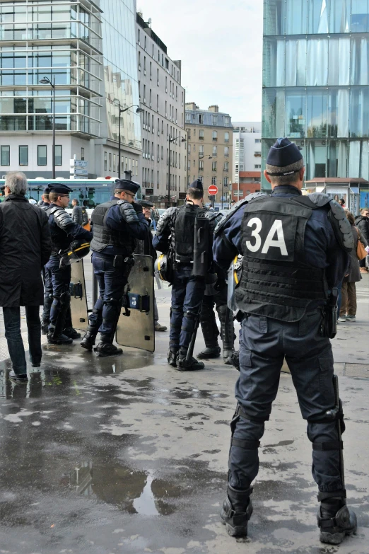 some cops are standing in front of a crowd