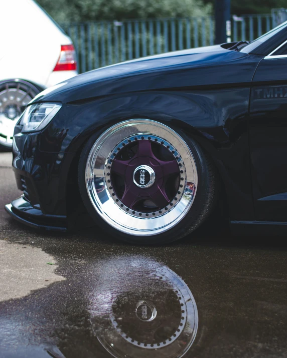 an elaborate chrome rim on a black car