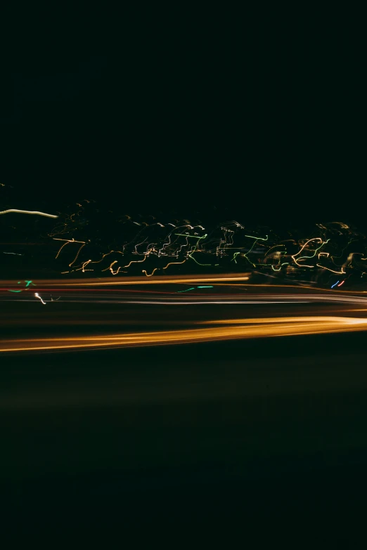 a view of a dark sky and the street lights from a car