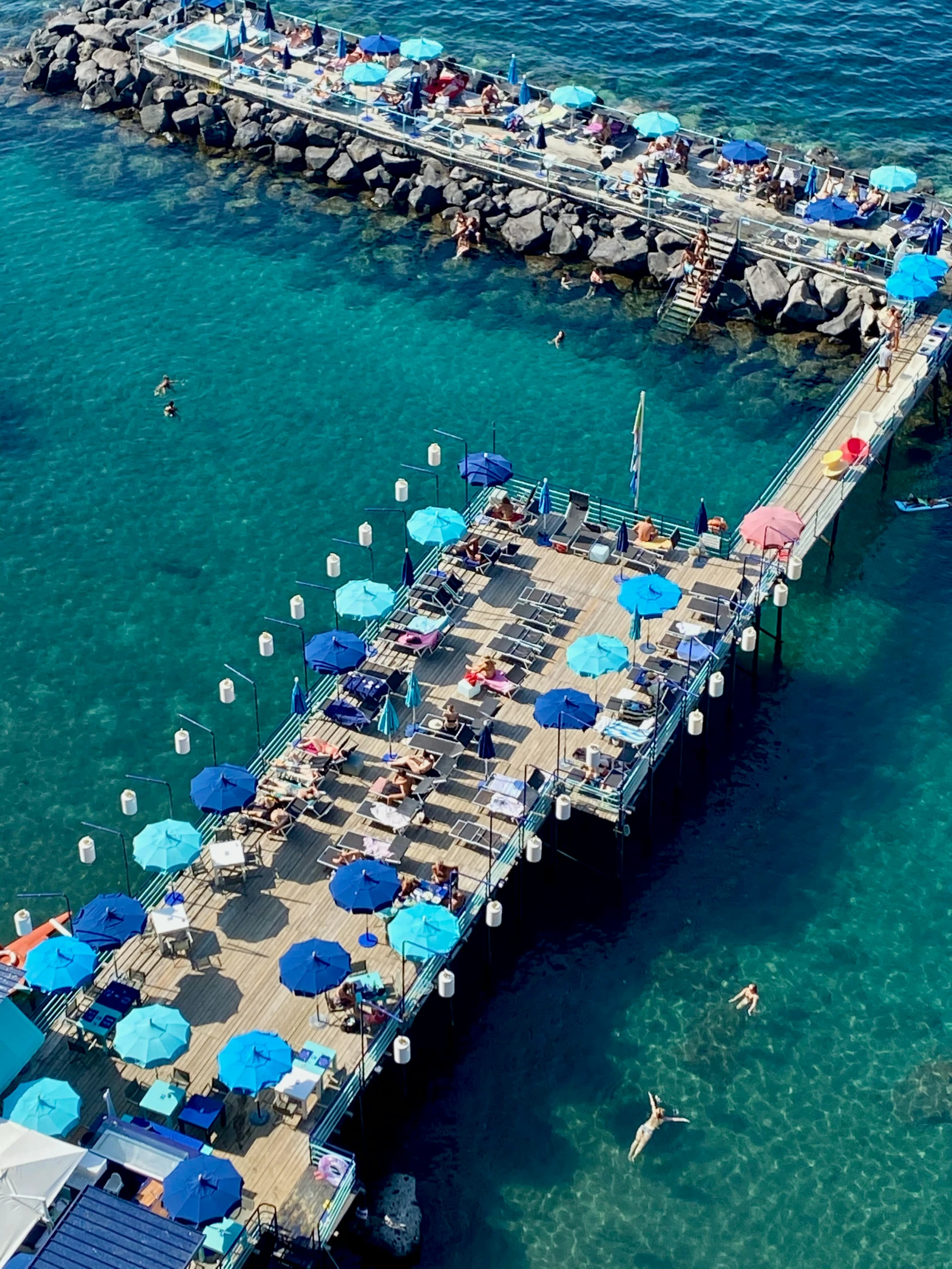 the beach is set up with umbrellas for shade