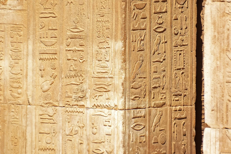 several egyptian stells in a line on a wall