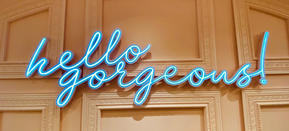 a large blue neon sign sitting on the wall