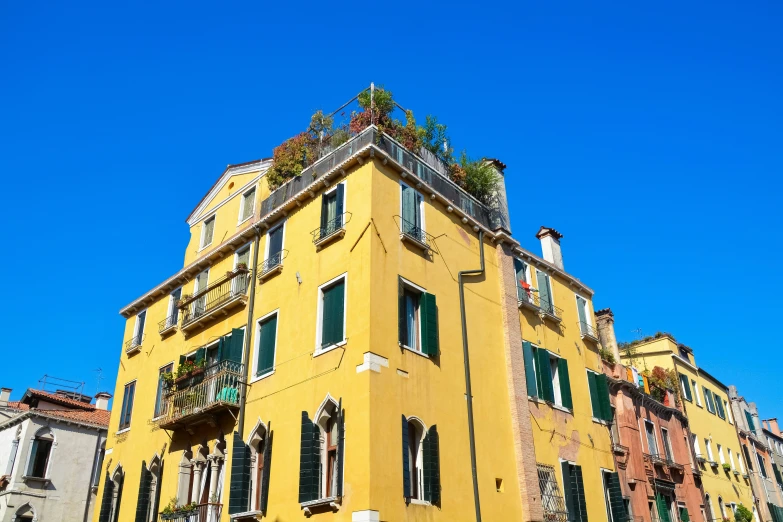 yellow building on a hill with lots of windows