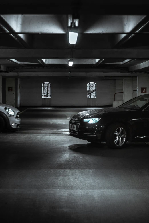 two cars parked in a car parking garage